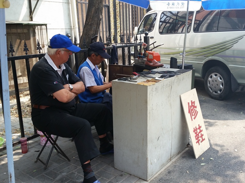 Clive with his shoe mender, Beijing.